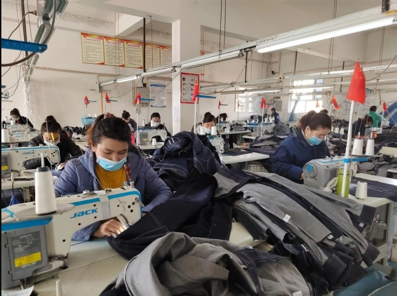 Workers make clothes in Guangzhou garment factory